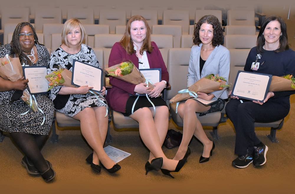 Pennsylvania Hospital’s five winners of the 2021 Penn Medicine Nursing Clinical Excellence Awards celebrate in Zubrow Auditorium. From left: Rhonda Whitaker, BSN, RN, CBC, a clinical nurse 4 in the Delivery Room; Ann Coughlin, MSN, RN, CMSRN, CBL, a clinical nurse 2 on 5 Cathcart; Florence Vanek, MSN, RN, NE-BC, director of Nursing Education, Professional Practice, and Magnet; Anna Wojtas, MSN, RN, CCRN, a clinical nurse 3 on the Vascular Access team; and Annemarie Deeley, MSN, RNC-NIC, CNL, a clinical nurse 4 in the Intensive Care Nursery.